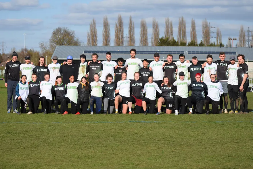 The Flyght Ultimate squad lined up for a group photo on a grass pitch