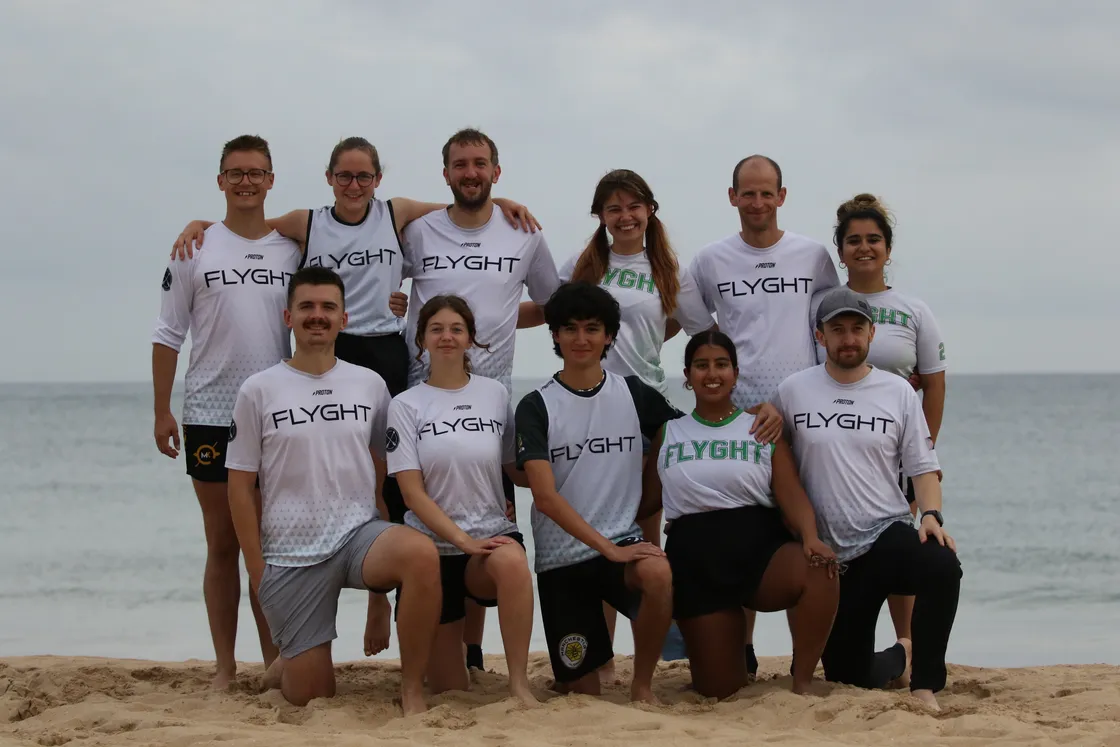 Flyght Ultimate members posing together on a beach